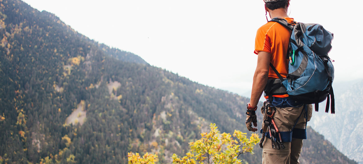 Man climbing mountain to reach goals