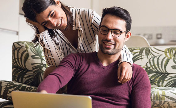 Young couple banking online at home