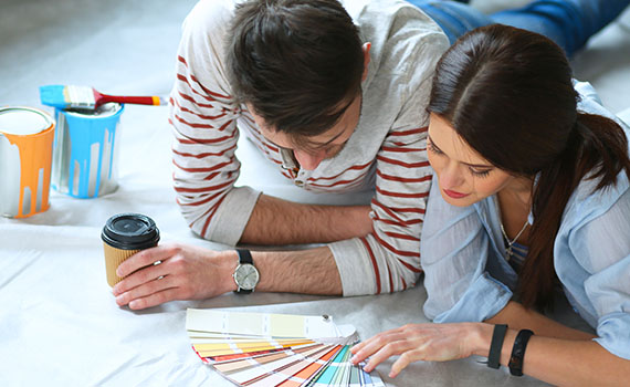 Young couple choosing paint color