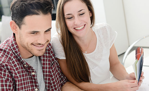 Happy young couple on computer