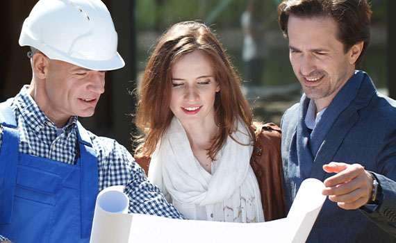 Happy couple working with builder on new home construction