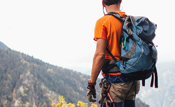 Man climbing mountain to reach goals